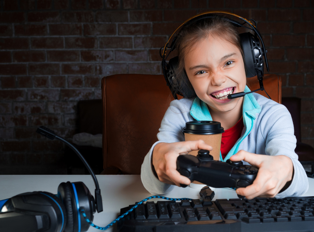 young-girl-big-headphones-with-microphone-is-sitting-front-monitor-playing-video-games-with-happy-excited-face-win.jpg
