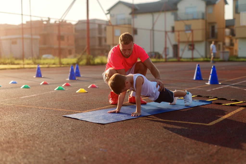 determinative-young-football-coach-learning-little-boy-how-push-ups.jpg